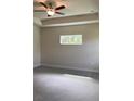 Main bedroom featuring a ceiling fan and window views at 3481 Nashville Rd, North Port, FL 34288