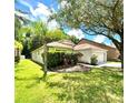 House with lush landscaping, featuring a two-car garage at 35216 Meadow Reach Dr, Zephyrhills, FL 33541