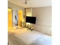 Spacious carpeted main bedroom with walk-in closet and TV at 6480 Center Lane, North Port, FL 34287