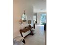 Modern entryway with console table and view to living room at 3101 Hollow Hickory Pl, Wesley Chapel, FL 33543