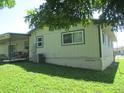 The expansive backyard features a covered patio area, great for outdoor enjoyment and shade at 4469 Keyes Ave, Spring Hill, FL 34606