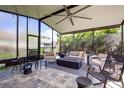 Spacious screened porch with fire pit and comfortable seating at 4224 Crayford Ct, Land O Lakes, FL 34638