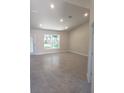 Spacious living room with natural light, tile flooring, and a walk-out glass door at 324 Galaxy Ave, Spring Hill, FL 34606