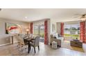 Bright dining area with water views and sliding glass doors to patio at 6476 Melacano Ave, Spring Hill, FL 34606