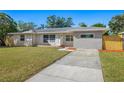 Updated single story home with new landscaping and driveway at 692 Oakwood Dr, Dunedin, FL 34698