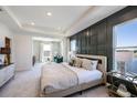Spacious main bedroom with large windows, a sitting area, and water views at 7479 Rome Ln, Brooksville, FL 34613