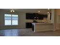 Modern kitchen with dark cabinetry, granite countertops, and stainless steel appliances at 13221 Gulf Bay Ln, Spring Hill, FL 34609