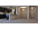 Open concept living space featuring tile flooring and a view into the kitchen at 13221 Gulf Bay Ln, Spring Hill, FL 34609