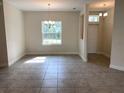 Open dining area with natural light from the large window and contemporary chandelier at 7724 Swiss Ave, North Port, FL 34291