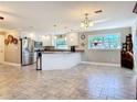 Bright kitchen features stainless steel appliances, white cabinets, granite countertops, and recessed lighting at 2457 Tamworth Ter, Punta Gorda, FL 33983