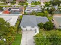 An aerial view of a two-story home with three-car garage in a residential neighborhood at 1731 Clearwater Harbor Dr, Largo, FL 33770