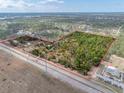 Aerial view showcases the expansive acreage and outlines the property's borders at 8279 Sunshine Grove Rd, Brooksville, FL 34613