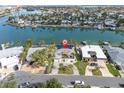 Single Gathering waterfront home with dock access, surrounded by lush landscaping and serene water views at 193 Mar St, St Pete Beach, FL 33706