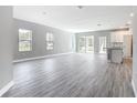Bright open-concept living room featuring hard surface floors and access to a kitchen at 2576 Pecan St, North Port, FL 34287
