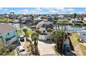 Waterfront property featuring a circular design, ample parking, and a well-manicured lawn at 4446 Bahama Dr, Hernando Beach, FL 34607