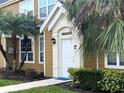 Front entryway with a well-lit doorway, complemented by lush, manicured landscaping at 5520 Rosehill Rd # 201, Sarasota, FL 34233