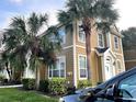 Charming two-story condo with neutral siding, white trim, and manicured landscaping at 5520 Rosehill Rd # 201, Sarasota, FL 34233