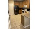 Functional kitchen with stainless steel refrigerator and white appliances at 4939 Marina Palms Dr, Port Richey, FL 34668