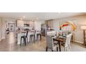 Open-concept kitchen and dining area with stainless steel appliances and a granite countertops at 5064 Roble Ave, Spring Hill, FL 34606
