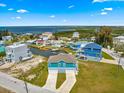 Aerial view of waterfront property with boat lift, surrounded by lush greenery and other homes at 6771 Seaview Blvd, Hudson, FL 34667