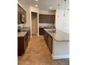 Well-equipped kitchen featuring stainless steel appliances, granite countertops, and dark wood cabinets at 1220 Gantry Rd, North Port, FL 34288