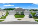Attractive home featuring well-maintained landscaping, an attached two-car garage, and a convenient circular driveway at 17663 Turning Leaf Cir, Land O Lakes, FL 34638