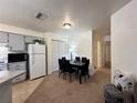 The open concept of this dining area is great for entertaining, featuring a contemporary table and great light at 4622 Blossom Blvd # D, Zephyrhills, FL 33542