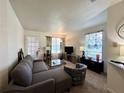 Cozy living room with ample seating and large windows with decorative curtains for bright, natural light at 4622 Blossom Blvd # D, Zephyrhills, FL 33542