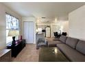 A comfortable living room open to kitchen and dining with a neutral color scheme and lots of natural light at 4622 Blossom Blvd # D, Zephyrhills, FL 33542