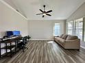 Bright living room featuring modern wood floors and neutral wall colors at 6212 Abbott Station Dr, Zephyrhills, FL 33542