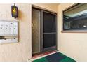 Welcoming front entrance with a decorative glass storm door and painted stucco siding at 2756 Clubhouse Dr # 101, Sarasota, FL 34232
