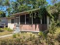 Charming single-story home with a cozy front porch and mature trees at 655 36Th S Ave, St Petersburg, FL 33705