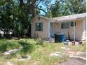 A front exterior view of the home with some overgrown landscaping, and basic architectural style at 665 36Th S Ave, St Petersburg, FL 33705