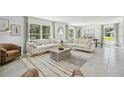 Bright and airy living room featuring two sofas, natural light, and an eye-catching rug at 30948 Silver Stage Dr, Brooksville, FL 34602