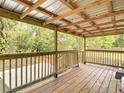 Spacious outdoor porch showcasing natural wood floors and railings, perfect for relaxing and entertaining at 6008 Angus Valley Dr, Wesley Chapel, FL 33544