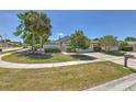 Well-manicured front yard with a mature trees and driveway at 7102 Silvermill Dr, Tampa, FL 33635
