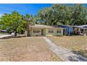 A cozy one-story home with tidy landscaping and healthy trees, perfect for suburban living at 107 W Woodlawn Ave, Tampa, FL 33603
