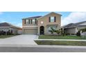 Charming home features a neat lawn, an attached two-car garage, and a welcoming entrance at 1739 Broad Winged Hawk Dr, Ruskin, FL 33570