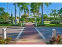 Beautifully landscaped street view with palm trees and decorative walkway in a walkable neighborhood at 3389 Pennyroyal Rd, Port Charlotte, FL 33953