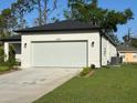A view of the house showing the garage and the well-maintained lawn surrounding it at 4097 Feather Ter, North Port, FL 34286