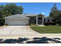 Charming single-story home with a two-car garage, well-manicured lawn, and inviting curb appeal at 9685 Southern Belle Dr, Weeki Wachee, FL 34613