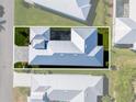 Aerial view of a home showcasing a modern metal roof and an enclosed pool at 10391 Coquina Ct, Placida, FL 33946
