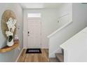 Bright foyer boasts wood-look flooring, stairs to the upper level, and a striking gold mirror accent at 30860 Wild Juniper Ct, Brooksville, FL 34602