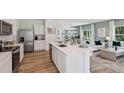 Open-concept kitchen features quartz countertops, stainless appliances, and seamless flow to the living area at 30860 Wild Juniper Ct, Brooksville, FL 34602