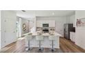 Bright kitchen featuring a center island with bar seating, modern appliances, and plenty of cabinet space for storage at 11777 Memorial Dr, Brooksville, FL 34613