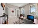 Home office with large windows, desk, and paneled wall feature at 11352 Curio Dr, Brooksville, FL 34613
