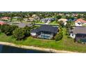 Aerial view of the home with a screened-in pool in a landscaped backyard, surrounded by a well-maintained neighborhood at 305 Lake Tahoe Ct, Englewood, FL 34223