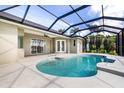 Inviting screened-in pool with bright blue water, and covered patio at 305 Lake Tahoe Ct, Englewood, FL 34223