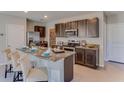 Open kitchen with stainless steel appliances, granite countertops, dark cabinetry, and center island with seating at 30823 Wild Juniper Ct, Brooksville, FL 34602