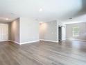 Open-concept living room features wood-look floors and a convenient sliding barn door at 3018 Oceanside St, North Port, FL 34286
